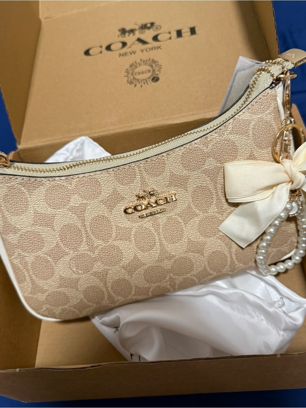 Coach Beige purse with bow Charm